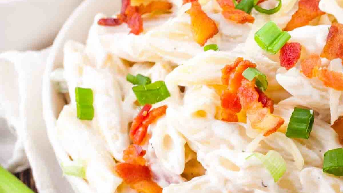A bowl of Bacon Ranch Pasta Salad filled with pasta, crispy bacon, colorful veggies, and creamy ranch dressing.