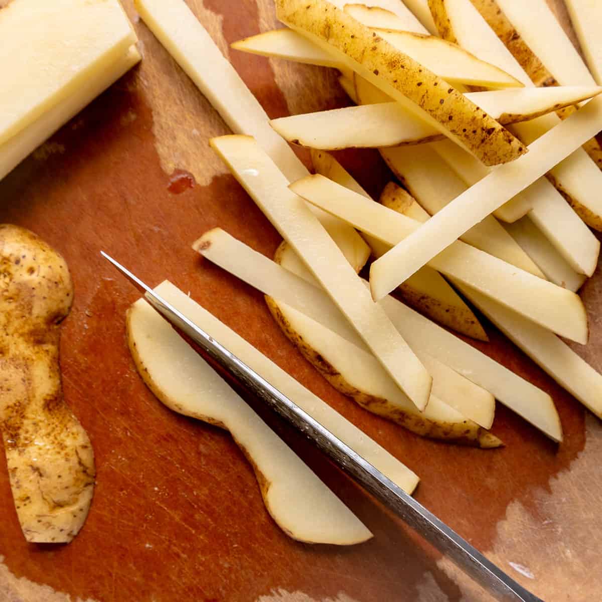 A knife slicing potatoes.