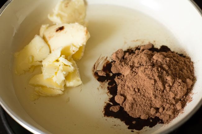 unsalted butter, oil and cocoa powder added in a pan. 
