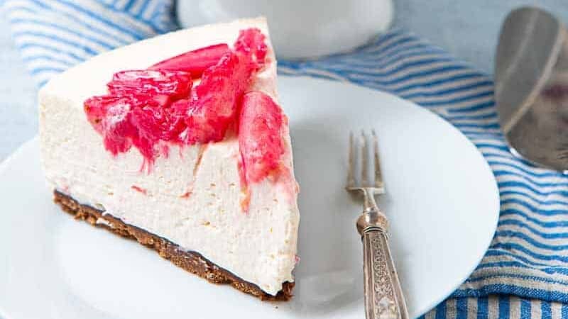 Whole No Bake Rhubarb Cheesecake and a slice removed